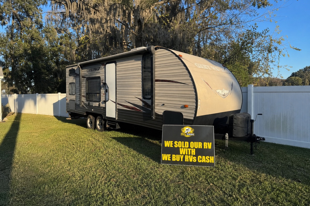 Travel trailer photographed from the rear of the lot — We Buy RVs Cash, Florida